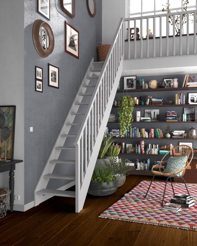 Escalier en bois blanc au dessus d'une bibliothèque dans un intérieur cosy