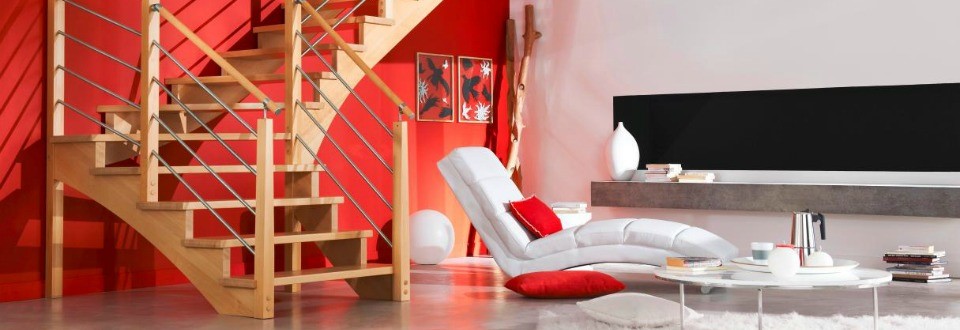 escalier en bois avec rampe en metal dans une salle rouge et blanche